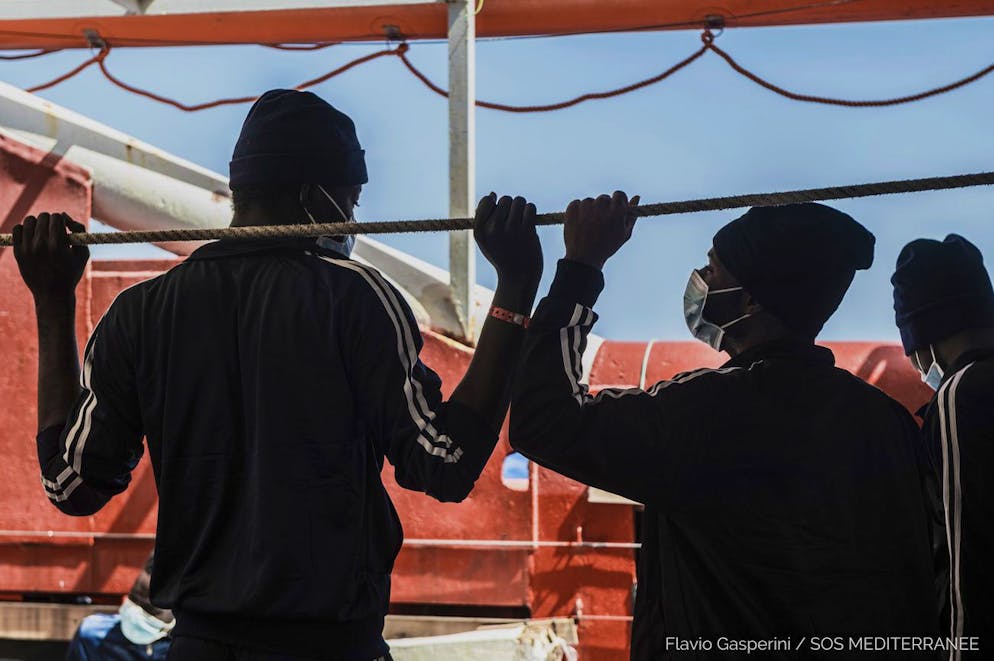 In this photo taken Thursday, April 29, 2021 migrants look at the sea from aboard the Ocean Viking during its navigation in the Mediterranean Sea. SOS Mediterranee said Saturday May 1, 2021 the Ocean Viking was sailing toward a Sicilian port with 236 migrants who were rescued days earlier in the Mediterranean from human traffickers' boats, while separately, Italy's coast guard and border police vessels brought 532 migrants rescued during the night to a tiny Italian island. (Flavio Gasperini/SOS Mediterranee via AP)