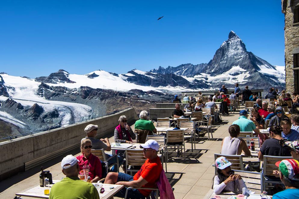 Des touristes profitent d'une terrasse depuis le Gornergrat en face du Cervin pendant la crise du Coronavirus (Covid-19) a l'occasion des vacances d'ete le mercredi 5 aout 2020 a Zermatt. (KEYSTONE/Jean-Christophe Bott)