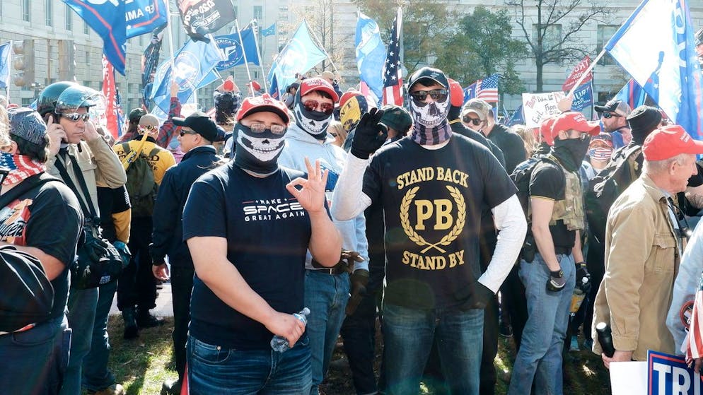epa08821070 Two people, one of them with a Proud Boys shirt, gesture with the White Power sign, as supporters of US President Donald J. Trump gather to support his legal challenges to the 2020 presidential election, in Freedom Plaza, in Washington, DC, USA, 14 November 2020. US President Donald J. Trump has refused to concede the 2020 Presidential election to his Democratic challenger President-Elect Joe Biden. EPA/GAMAL DIAB