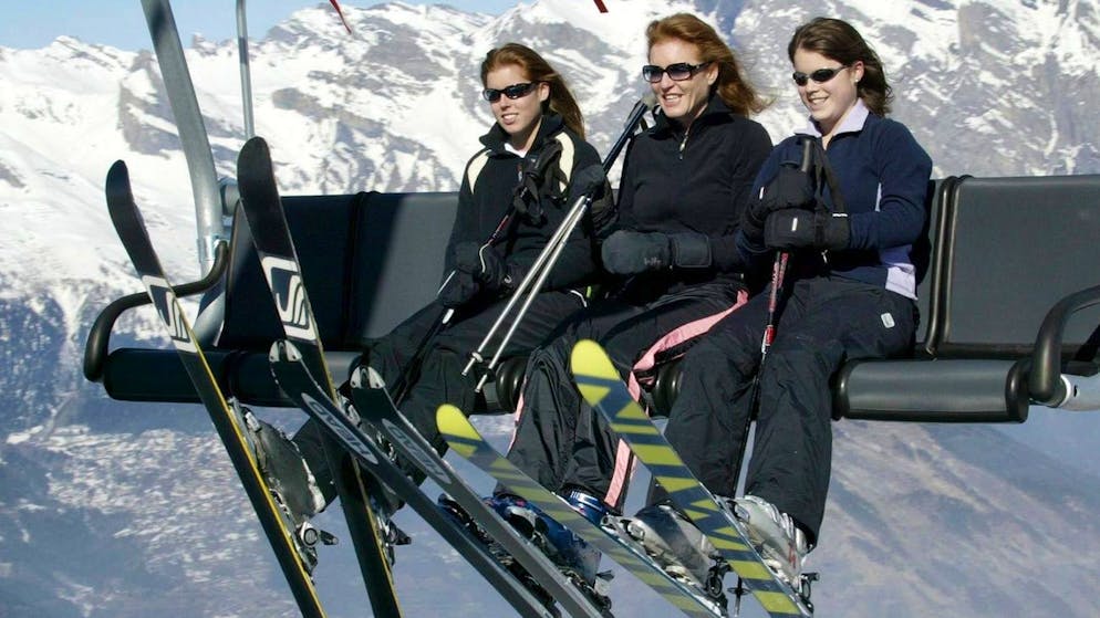 The Duchess of York rides a ski-lift with her daughters Princesses Beatrice (left) and Eugenie (right) above the slopes of Verbier in Switzerland Monday February 16, 2004, where the three are enjoying a holiday. (KEYSTONE/EPA/Gareth Fuller) === UK AND IRELAND OUT ===
