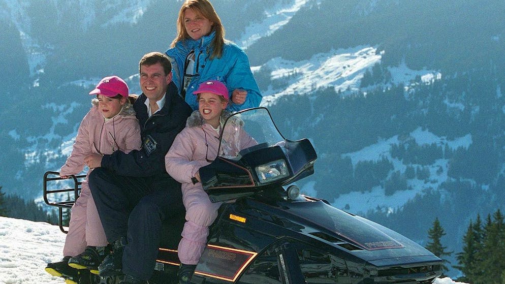 Britain's Prince Andrew and his ex-wife, Duchess of York Sarah Ferguson, pose with their two daughters Eugenie (left) and Beatrice, on a snowbike, in the ski ressort of Verbier, Switzerland, on February 19, 1998. Prince Andrew have joined his family for his today's 38th birthday. (KEYSTONE/Fabrice Coffrini)