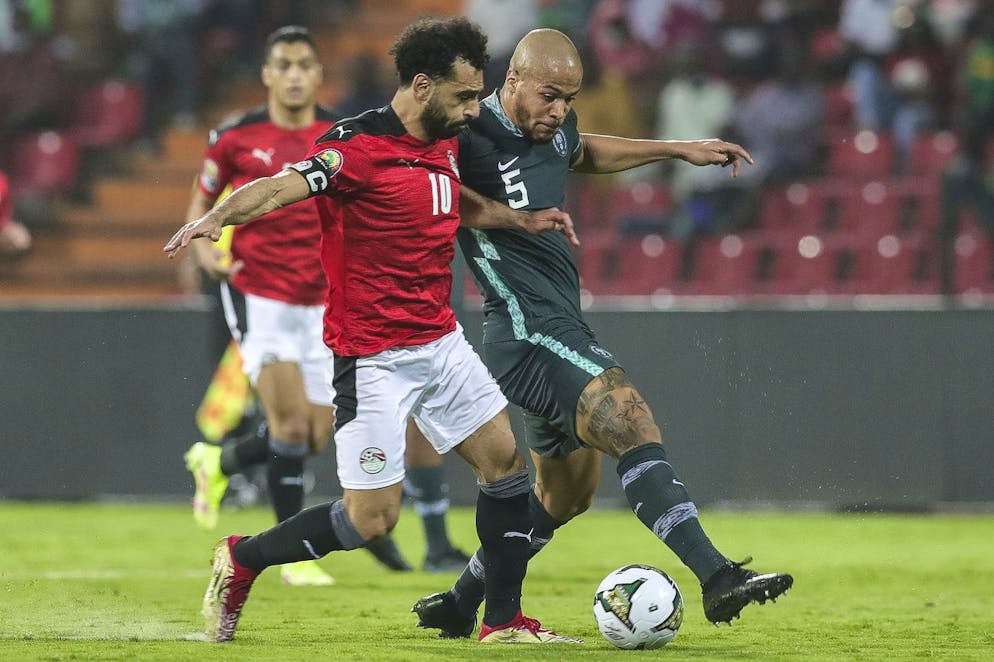 Egypt's Mohamed Salah, left, and Nigeria's William Troost-Ekong fight for the ball during the African Cup of Nations Group D soccer match between Egypt and Nigeria in Garoua, Cameroon, Tuesday, Jan. 11, 2022. (AP Photo/Footografiia)