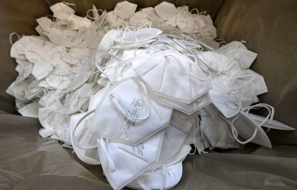 FFP2 face masks against the spread of the coronavirus are seen at the production of German producer Sentias in Wuppertal, Germany, Thursday, Jan. 28, 2021. Germany introduced new rules for the types of mask to wear when travelling on public transport or shopping. Medical masks became mandatory to fight the COVID-19 pandemic. (AP Photo/Martin Meissner)