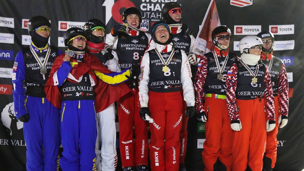 epa07351768 (L-R) Jiax Sun, Mengtago Xu, Xindi Wang, from China, Nicolas Gygaxx, Carol Bouvard, Noe Roth from Switzerland, Stanislav Nikitin, Liubov Nikitina and Maxim Burov from Russia celebrate their top three finishes in the Team Aerials competition at Deer Valley Resort during the FIS World Championships in Park City, Utah, 07 February 2019. EPA/GEORGE FREY