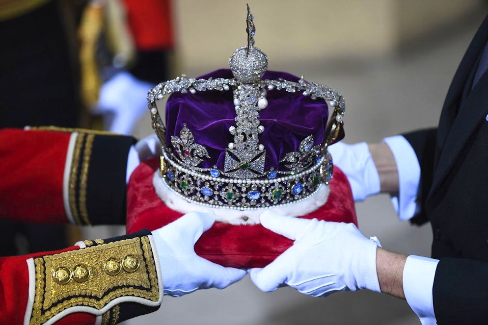 The Imperial State Crown is handed over for the State Opening of Parliament by Queen Elizabeth II, in the House of Lords at the Palace of Westminster in London, Thursday Dec. 19, 2019. (Victoria Jones, Pool via AP)