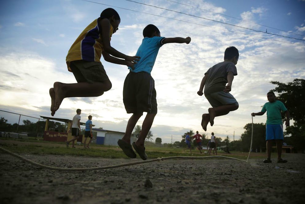 In this Sept. 12, 2013 photo, children jump rope near the baseball field where New York Yankee pitcher Mariano Rivera played during his childhood in his hometown of Puerto Caimito, Panama. Rivera and his friends played baseball on the beach with tennis balls, or balls fashioned from fish nets. Bats were made from branches from the mangrove swamps, and gloves were empty milk cartons. (AP Photo/Arnulfo Franco)