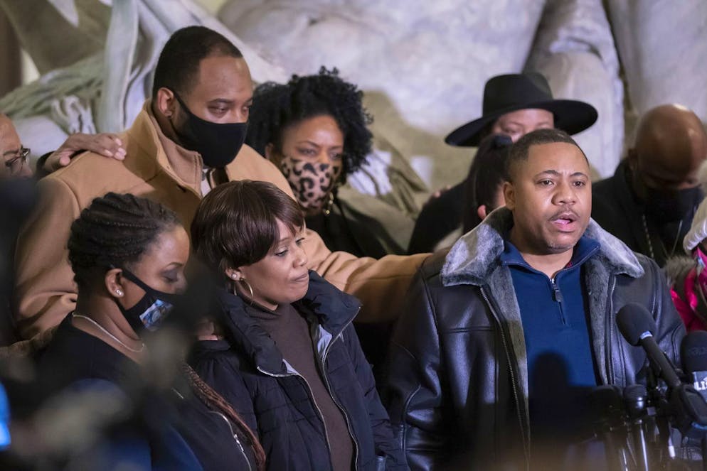 Amir Locke's father Andre Locke speaks at the press conference, with Amir's mother Karen Wells, on the left, Friday, Feb. 4, 2022, in Minneapolis. Communities United Against Police Brutality held a press conference at City Hall to ask questions on police action related to the killing of Amir Locke. The Minneapolis mayor imposed a moratorium on no-knock warrants Friday, two days after a SWAT team entered a downtown apartment and killed Amir Locke, a Black man who his parents said was âÄœexecutedâÄ after he was startled from a deep sleep and reached for a legal firearm to protect himself. (Glen Stubbe/Star Tribune via AP)