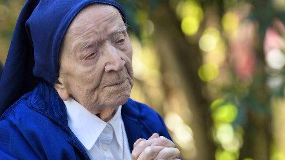 Sister Andre, Lucile Randon in the registry of birth, the eldest French and European citizen, prays in a wheelchair, on the eve of her 117th birthday - born on February 11, 1904 - in an EHPAD (Housing Establishment for Dependant Elderly People) in Toulon, southern France, where she has been living since 2009. - Sister Andre was touched by the Covid-19 in January 2021. (Photo by NICOLAS TUCAT / AFP)