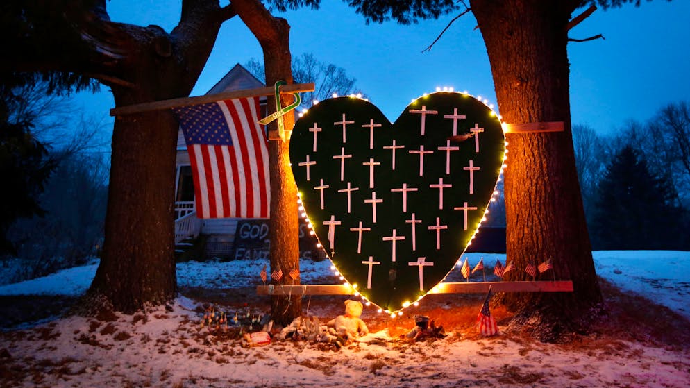 FILE - In this Saturday, Dec. 14, 2013, file photo, a makeshift memorial with crosses for the victims of the Sandy Hook massacre stands outside a home in Newtown, Conn., the one-year anniversary of the shootings. Connecticut authorities said they planned Friday, Dec. 27, 2013, to release state police documents from the investigation into last year's Newtown school massacre. (AP Photo/Robert F. Bukaty, File)