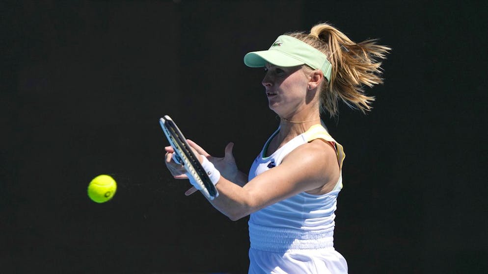 Jil Teichmann of Switzerland plays a forehand return to Victoria Azarenka of Belarus during their second round match at the Australian Open tennis championships in Melbourne, Australia, Wednesday, Jan. 19, 2022. (AP Photo/Simon Baker)