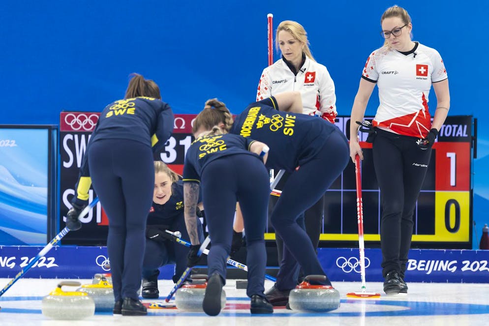 Switzerland skip Silvana Tirinzoni, 2nd right, and her teammate Alina Paetz, right, observe Sweden team during the women's curling bronze medal game between Switzerland and Sweden at the National Aquatics Centre at the 2022 Olympic Winter Games in Beijing, China, on Saturday, February 19, 2022. (KEYSTONE/Salvatore Di Nolfi)