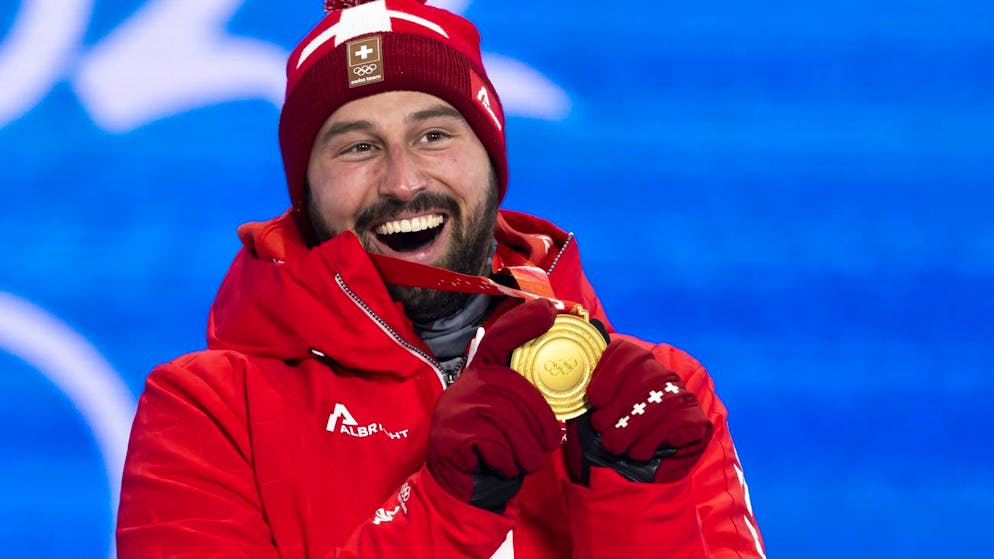 Ryan Regez of Switzerland, gold medal winner in the men's ski freestyle cross competition, poses with his medal during the medal ceremony at the 2022 Winter Olympics in Zhangjiakou, China, on Friday, February 18, 2022. (KEYSTONE/Peter Klaunzer)..