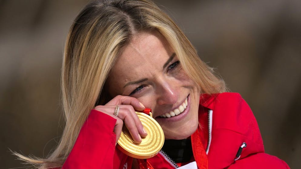 Lara Gut-Behrami, of Switzerland reacts as she celebrates during the medal ceremony after winning the gold medal in the women's super-G at the 2022 Winter Olympics, Friday, Feb. 11, 2022, in the Yanqing district of Beijing. (AP Photo/Luca Bruno)