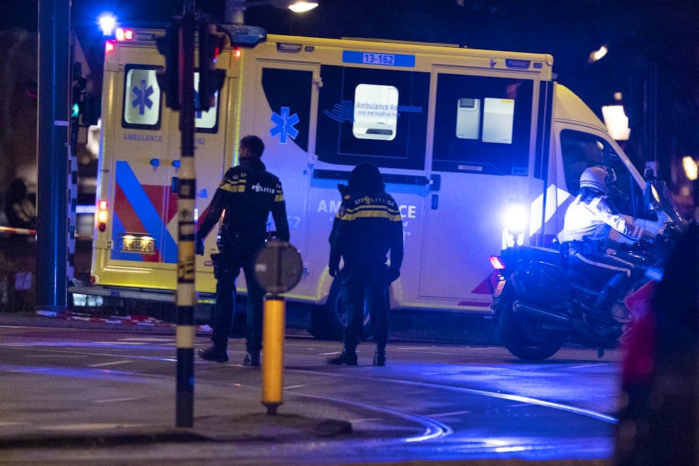 An ambulance transporting the injured hostage taker leaves the scene in Amsterdam, Netherlands, Tuesday, Feb. 22, 2022, where the armed person was holed up in the Amsterdam Apple Store with at least one hostage in an hours-long standoff with scores of police massed outside. (AP Photo/Peter Dejong)