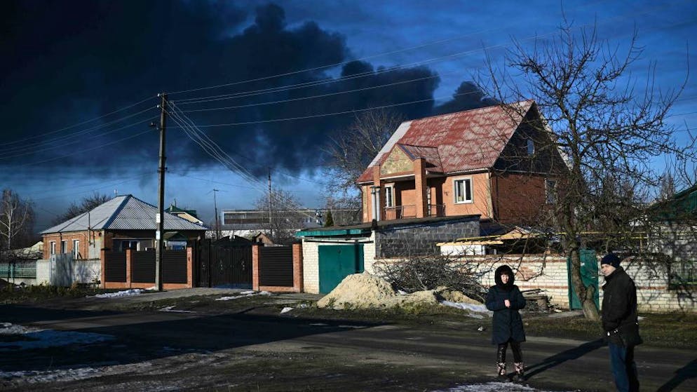 Black smoke rises from a military airport in Chuguyev near Kharkiv  on February 24, 2022. - Russian President Vladimir Putin announced a military operation in Ukraine on Thursday with explosions heard soon after across the country and its foreign minister warning a 