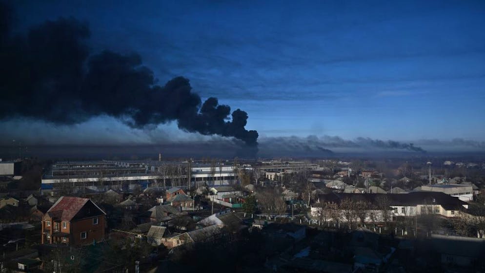 TOPSHOT - Black smoke rises from a military airport in Chuguyev near Kharkiv on February 24, 2022. - Russian President Vladimir Putin announced a military operation in Ukraine today with explosions heard soon after across the country and its foreign minister warning a