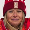 Corinne Suter, of Switzerland, gold, reacts during the medal ceremony for the women's downhill at the 2022 Winter Olympics, Tuesday, Feb. 15, 2022, in the Yanqing district of Beijing. (AP Photo/Luca Bruno)