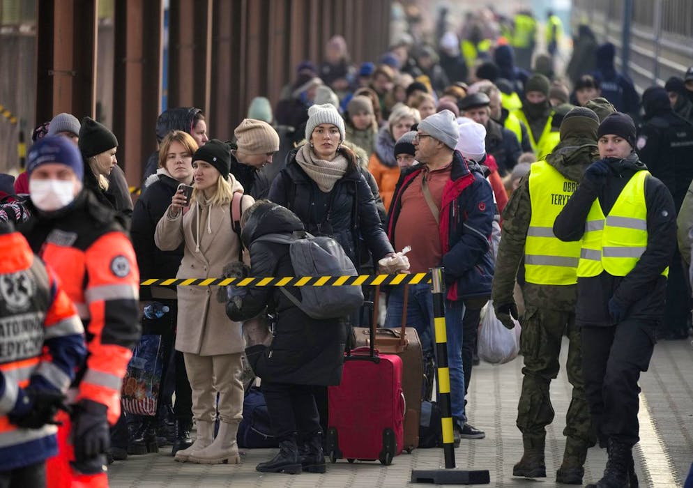 Displaced Ukrainians stand in a line on the train platform after arriving from Ukraine at the station in    Przemysl, Poland, Thursday, March 3, 2022. More than 1 million people have fled Ukraine following Russia's invasion in the swiftest refugee exodus in this century, the United Nations said Thursday. (AP Photo/Markus Schreiber)