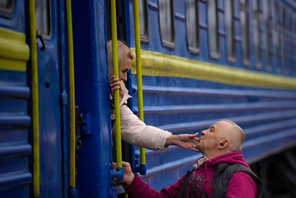 A woman bids a man goodbye after boarding a Lviv bound train, in Kyiv, Ukraine, Thursday, March 3, 2022. (AP Photo/Vadim Ghirda)