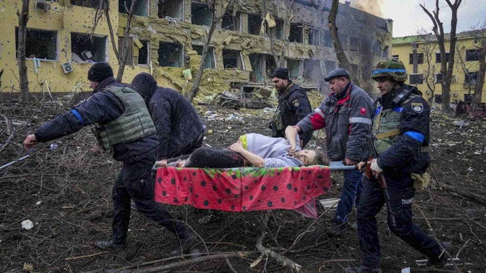 Una donna incinta viene portata via dopo che l'ospedale di Mariupol è stato distrutto da un raid aereo russo.