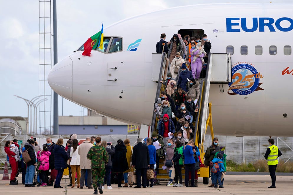 Refugees from Ukraine disembark from a charter plane arriving from Poland, at the military airport in Lisbon, Thursday, March 10, 2022. A U.N. agency and others tracking migration say 2 million people have fled Ukraine in the two weeks since Russia's invasion. (AP Photo/Armando Franca)