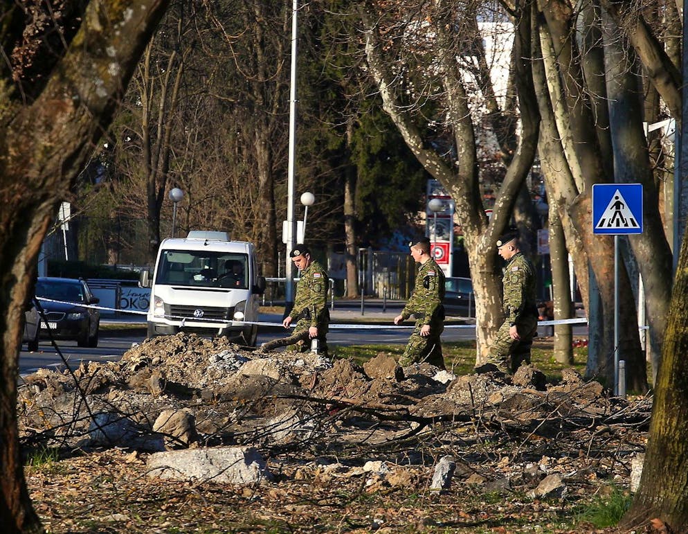 Croatian soldiers investigate the site of a March 11, 2022, drone crash in Zagreb, Croatia.  The Croatian Defense Ministry has confirmed that an unidentified military drone crashed in the city center of Zagreb on March 11.