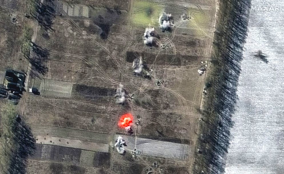 This multispectral satellite image provided by Maxar Technologies shows an artillery battalion actively firing in a southeasterly direction near Antonov Airport, during the Russian invasion, in Ozera, Ukraine, Friday, March 11, 2022. (Satellite image ©2022 Maxar Technologies via AP)