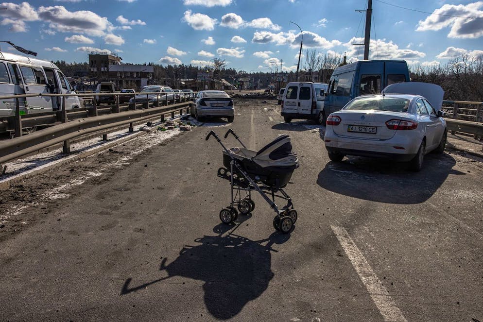 epa09815291 An abandoned stroller stands on a destroyed bridge as people flee from the frontline town of Irpin, Kyiv (Kiev) region, Ukraine, 10 March 2022. Thousands of residents are feeling Irpin and Bucha, as well as other settlements near Kyiv which were the most affected by the Russian army invasion. EPA/ROMAN PILIPEY