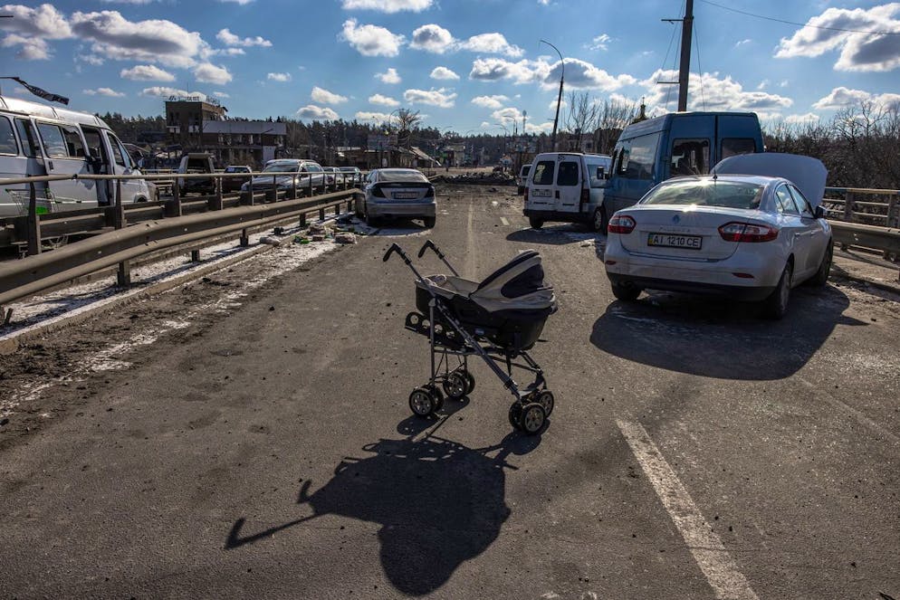 epa09815291 An abandoned stroller stands on a destroyed bridge as people flee from the frontline town of Irpin, Kyiv (Kiev) region, Ukraine, 10 March 2022. Thousands of residents are feeling Irpin and Bucha, as well as other settlements near Kyiv which were the most affected by the Russian army invasion. EPA/ROMAN PILIPEY