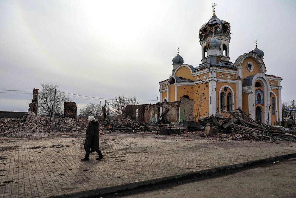 epa09819961 A woman passes near the Rus Orthodox Foreign Church partially destroyed after being bombed by Russian aircraft, in Malyn, Ukraine, 12 March 2022. Russian troops entered Ukraine on 24 February prompting the country's president to declare martial law and triggering a series of announcements by Western countries to impose severe economic sanctions on Russia. EPA/MIGUEL A. LOPES