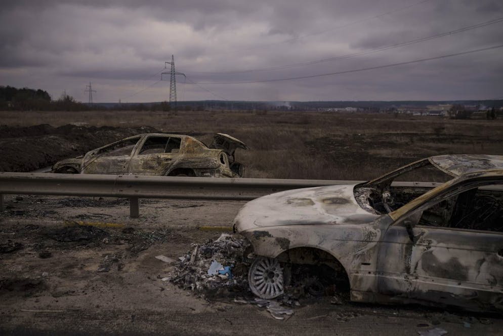 Destroyed cars on a road being used as an evacuation route out of Irpin, on the outskirts of Kyiv, Ukraine, Sunday, March 13, 2022. (AP Photo/Felipe Dana)