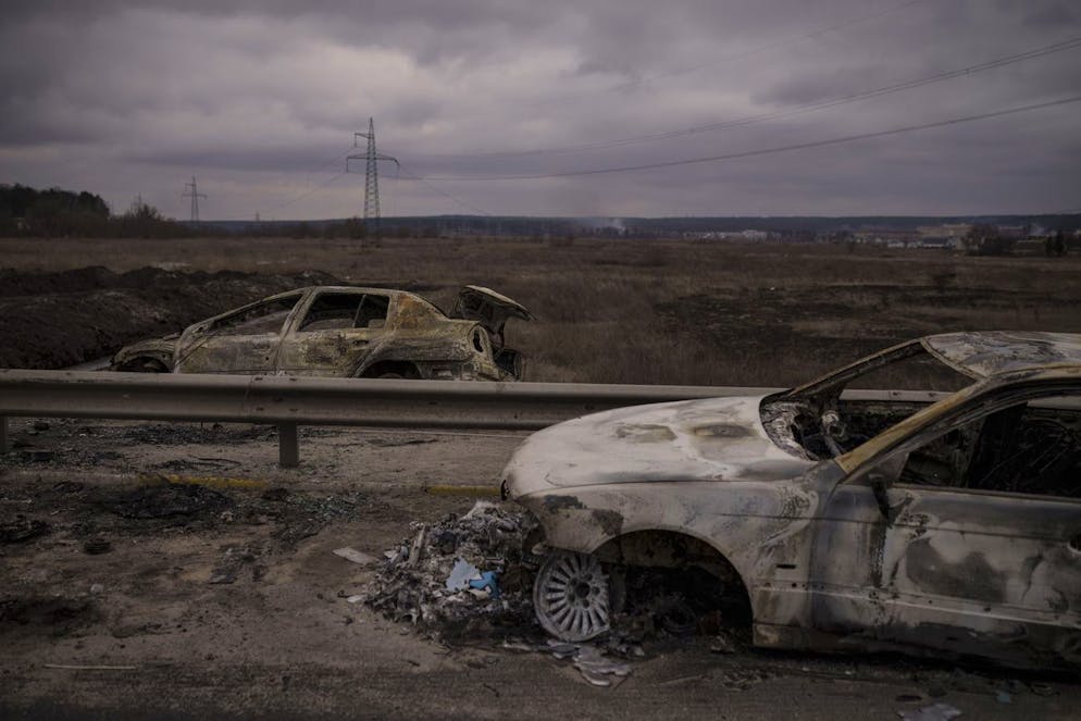 Destroyed cars on a road being used as an evacuation route out of Irpin, on the outskirts of Kyiv, Ukraine, Sunday, March 13, 2022. (AP Photo/Felipe Dana)