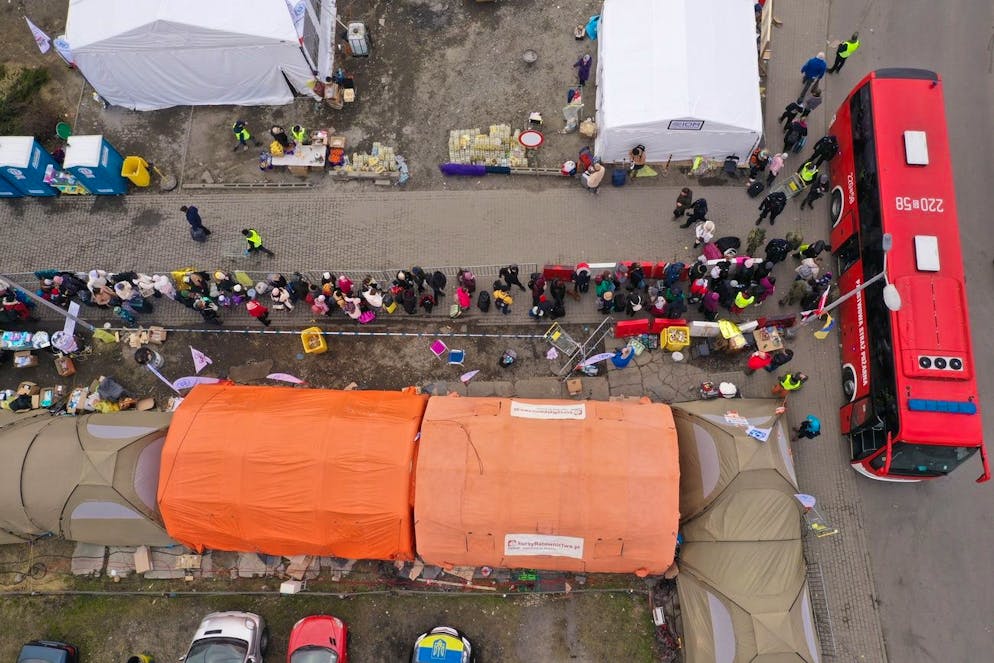 An aerial view of refugees queuing for transport at the border crossing at Medyka, Poland, Sunday March 13, 2022, where the main flow of Ukrainian refugees cross into Poland. The U.N. refugee agency says more than 2.5 million people, including more than a million children, have already fled Ukraine. It has become an unprecedented humanitarian crisis in Europe and the fastest refugee exodus since World War II. (AP Photo)