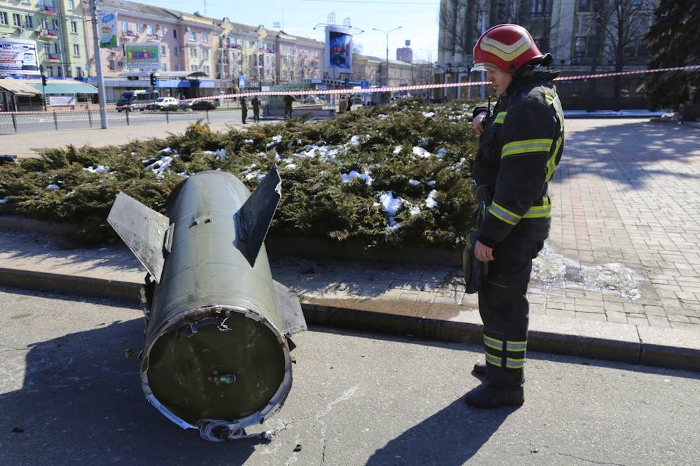 A firefighter looks at a fragment of a Ukrainian Tochka-U missile on a street in Donetsk in eastern Ukraine, Monday, March 14, 2022. The Russian military says that 20 civilians have been killed by a ballistic missile launched by the Ukrainian forces. Russian Defense Ministry spokesman Maj. Gen. Igor Konashenkov said that the Soviet-made Tochka-U missile on Monday hit the central part of the eastern city of Donetsk, the center of the separatist Donetsk region. (AP Photo/Alexei Alexandrov)