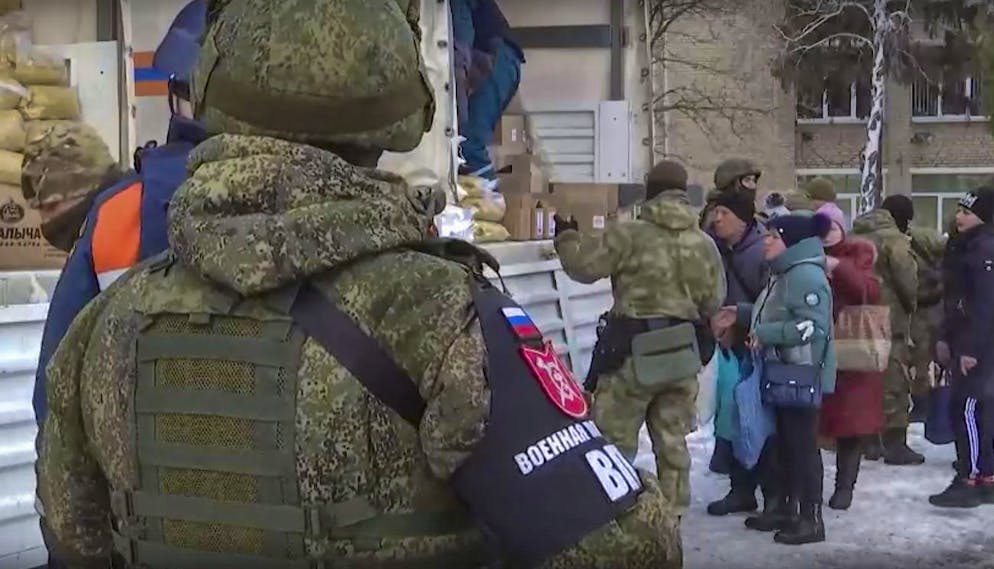 epa09829113 A handout still image taken from handout video made available by the Russian Defence ministry press-service shows Russian serviceman guard near a place where the Russian humanitarian aid for Ukrainian people are handed out, in Kharkiv region, Ukraine, 16 March 2022. On 24 February Russian troops had entered Ukrainian territory in what the Russian president declared a 'special military operation', resulting in fighting and destruction in the country, a huge flow of refugees, and multiple sanctions against Russia. EPA/RUSSIAN DEFENCE MINISTRY PRESS SERVICE / HANDOUT HANDOUT EDITORIAL USE ONLY/NO SALES