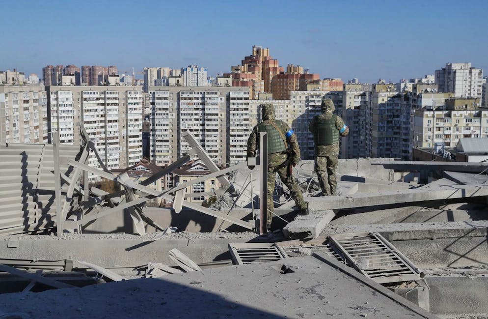epa09830865 Ukrainian servicemen investigate the damaged floor of the residential building which was shelled last night in Kyiv, Ukraine, 17 March 2022. One person was killed and three injured during the shelling. Russian troops entered Ukraine on 24 February prompting the country's president to declare martial law and triggering a series of announcements by Western countries to impose severe economic sanctions on Russia. EPA/SERGEY DOLZHENKO