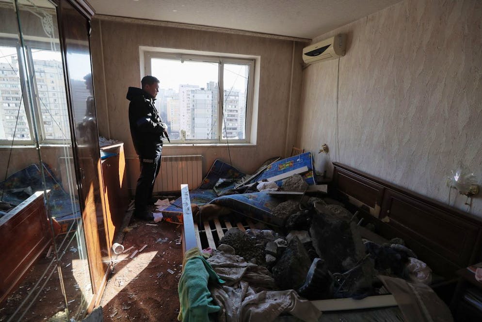 epa09830838 A policeman stands in damaged flat at the residential building which was shelled last night in Kyiv, Ukraine, 17 March 2022. One person was killed and three injured during the shelling. Russian troops entered Ukraine on 24 February prompting the country's president to declare martial law and triggering a series of announcements by Western countries to impose severe economic sanctions on Russia. EPA/SERGEY DOLZHENKO