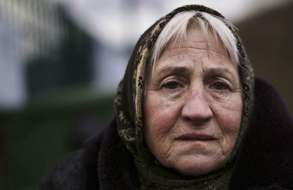 Svetlana, 76, who fled from Odesa, Ukraine, sits at the border crossing in Kroscienko, Poland, Tuesday, March 8, 2022. (AP Photo/Markus Schreiber)