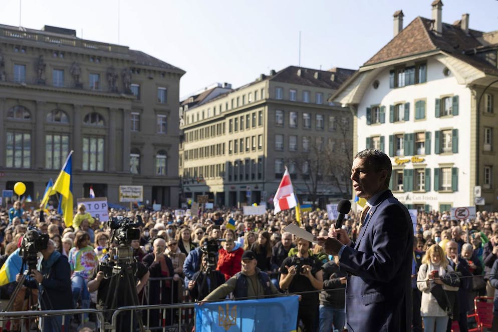 Swiss Federal President Ignazio Cassis speaks during a demonstration against the Russian invasion of Ukraine in front of the Swiss parliament building in Bern, Switzerland, Saturday, March 19, 2022. (KEYSTONE/Peter Klaunzer)
