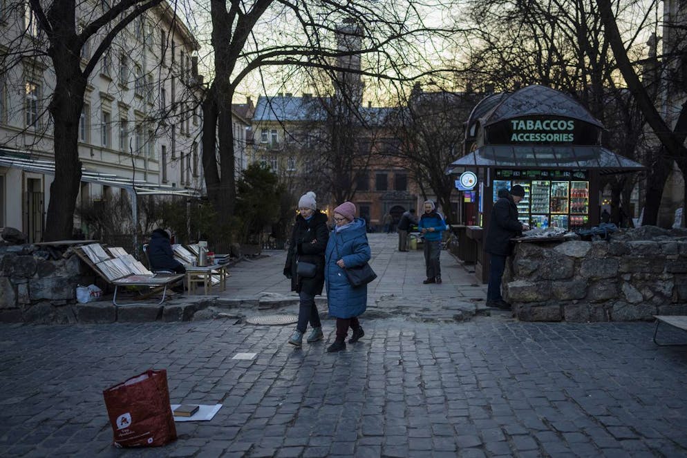 Pedestrians walk in downtown Lviv, Western Ukraine, Saturday, March 19, 2022. Lviv has been a refuge since the war began nearly a month ago, the last outpost before Poland and host to hundreds of thousands of Ukrainians streaming through or staying on. (AP Photo/Bernat Armangue)
