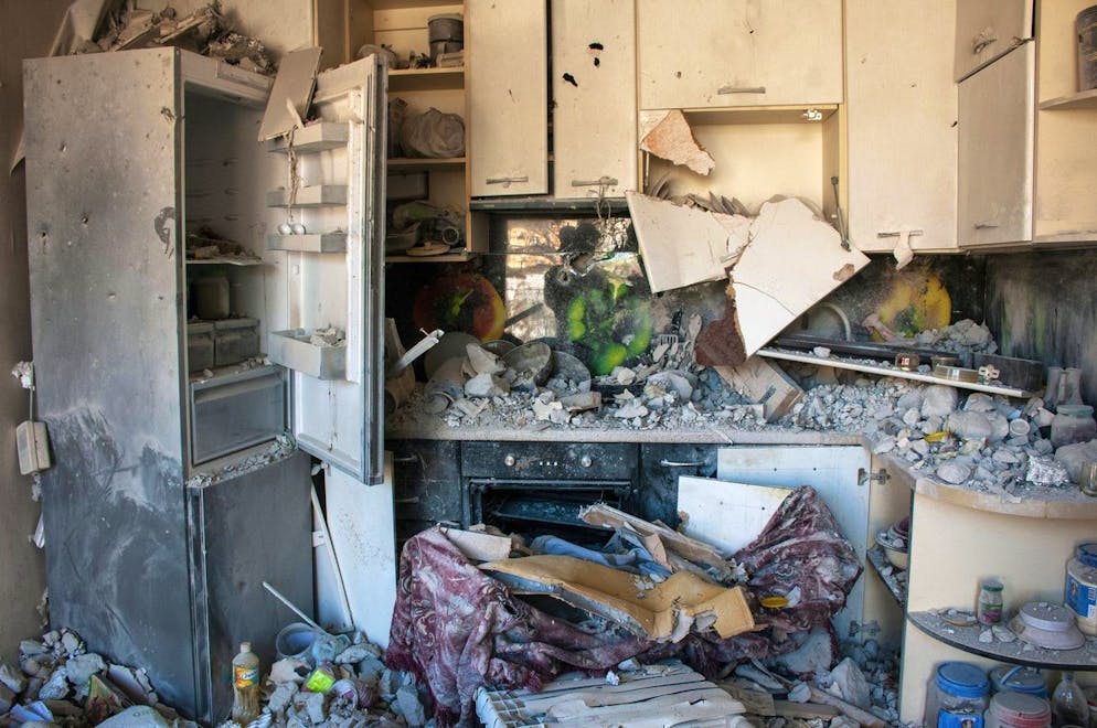 Utensils are seen inside a damaged kitchen at an apartments building hit by shelling in Kharkiv, Ukraine, Sunday, March 20, 2022. (AP Photo/Andrew Marienko)