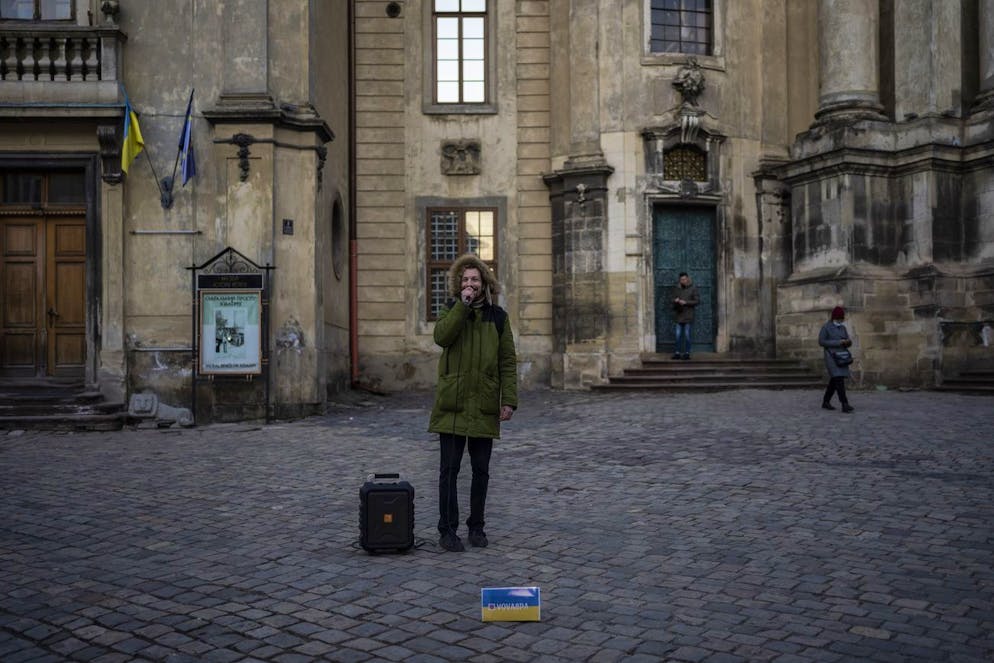 A man recites a poem in downtown Lviv, Western Ukraine, Saturday, March 19, 2022. Lviv has been a refuge since the war began nearly a month ago, the last outpost before Poland and host to hundreds of thousands of Ukrainians streaming through or staying on. (AP Photo/Bernat Armangue)