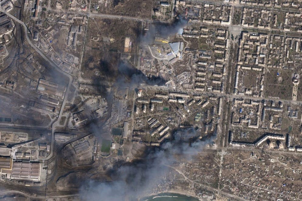 In this satellite photo from Planet Labs PBC, multiple civilian buildings burn amid Russian strikes on the Livoberezhnyi District of Mariupol, Ukraine, Sunday, March 20, 2022. Ukrainian authorities said Sunday that Russia's military bombed an art school sheltering some 400 people in the port city of Mariupol, where heavy street fighting was underway weeks into a devastating Russian siege. (Planet Labs PBC via AP)