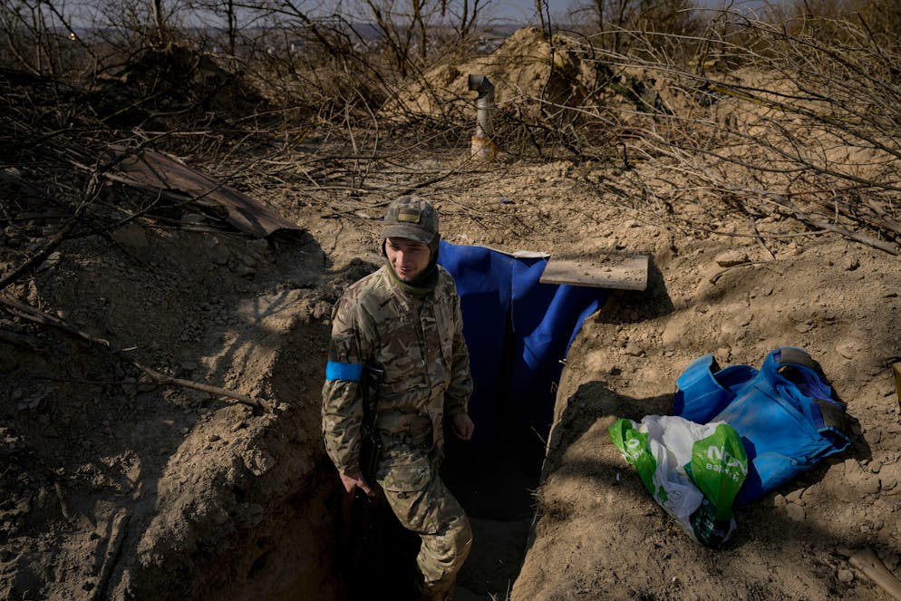 A Ukrainian serviceman stands outside a bunker on the outskirts of Kyiv, Ukraine, Sunday, March 20, 2022. Russian forces pushed deeper into Ukraine's besieged and battered port city of Mariupol on Saturday, where heavy fighting shut down a major steel plant and local authorities pleaded for more Western help. (AP Photo/Vadim Ghirda)