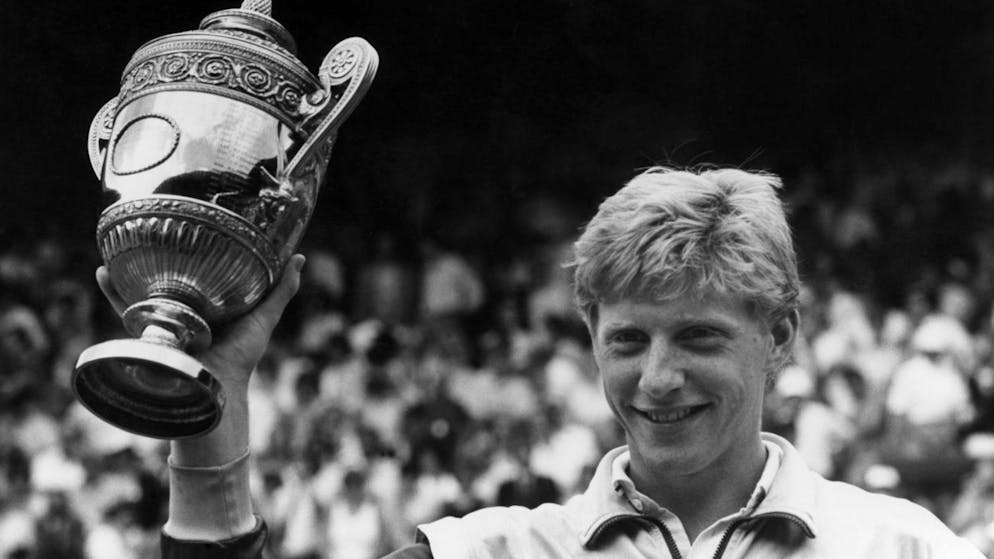 Boris Becker displays his trophy on the Centre Court at Wimbledon on Sunday, July 6, 1986, after winning the Men's Singles Championship. Becker defeated Ivan Lendl 6-4, 6-3, 7-5, to take the championship for the second consecutive year. (AP Photo/Robert Dear)