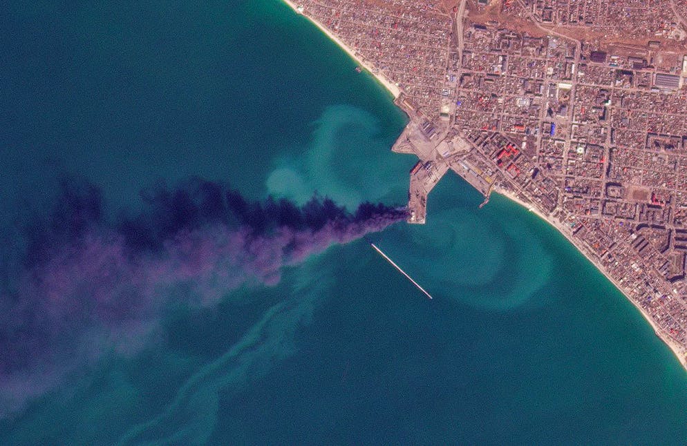 In this satellite photo from Planet Labs PBC, smoke rises after an attack that Ukraine's navy said sank a large Russian landing ship in the port city of Berdyansk, Ukraine, Thursday, March 24, 2022. Ukraine's navy said Russia had used the vessel to ferry in armored vehicles. (Planet Labs PBC via AP)