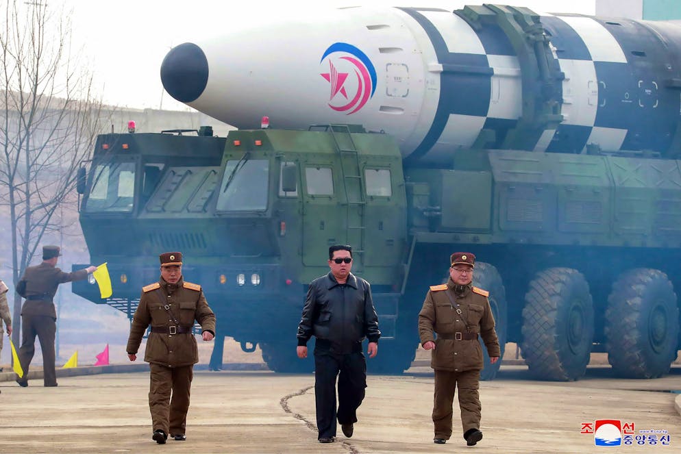 In this photo distributed by the North Korean government, North Korean leader Kim Jong Un, center, walks around what it says a Hwasong-17 intercontinental ballistic missile (ICBM) on the launcher, at an undisclosed location in North Korea on March 24, 2022. Independent journalists were not given access to cover the event depicted in this image distributed by the North Korean government. The content of this image is as provided and cannot be independently verified. Korean language watermark on image as provided by source reads: