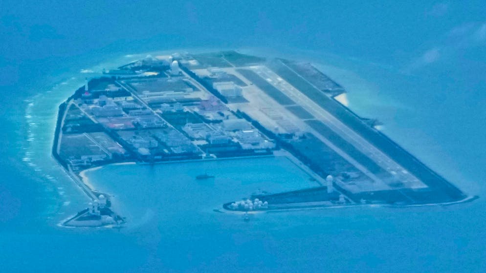 Chinese structures and buildings at the man-made island on Mischief Reef at the Spratlys group of islands in the South China Sea are seen on Sunday March 20, 2022. China has fully militarized at least three of several islands it built in the disputed South China Sea, arming them with anti-ship and anti-aircraft missile systems, laser and jamming equipment and fighter jets in an increasingly aggressive move that threatens all nations operating nearby, a top U.S. military commander said Sunday. (AP Photo/Aaron Favila)