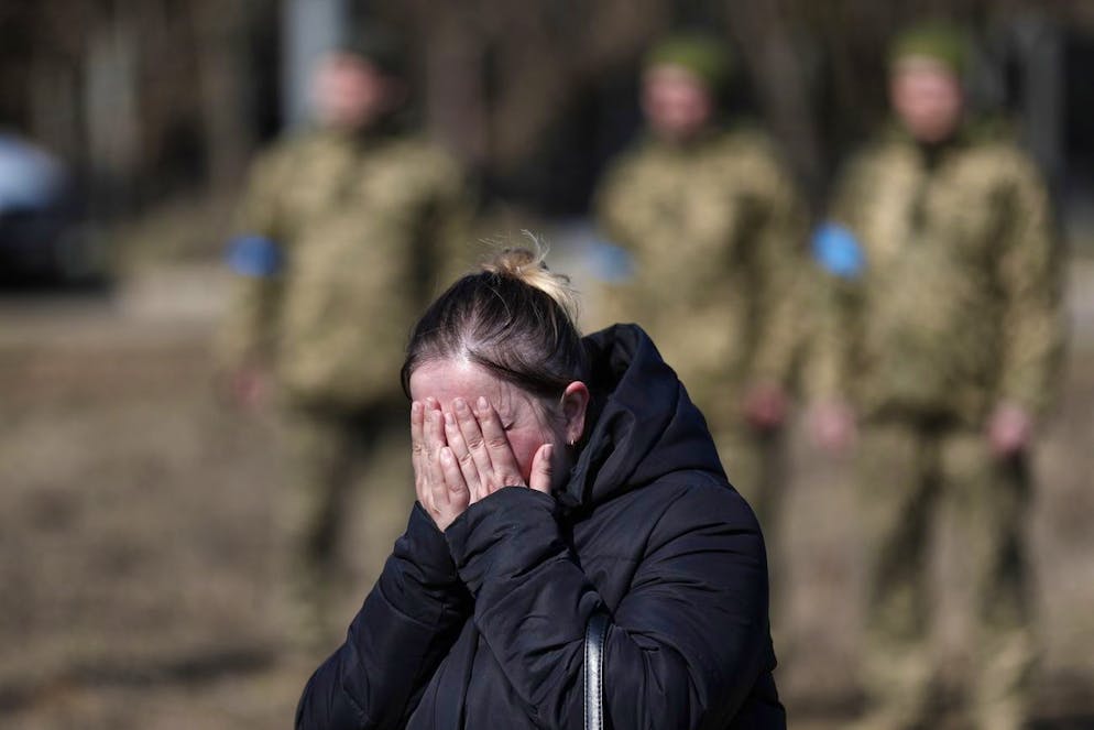 epa09848655 A woman reacts during Ukrainian Mobilized volunteer, Valery Resinsky (45), funeral in the capital city of Kyiv, Ukraine, 25 March 2022. Resinsky, from the village of Dmytrivka in the Kyiv region, was killed during the fights with Russian troops in Kharkiv region. His family couldn't bury him in his home village of Dmitrovka due to fighting in the city. Russian troops entered Ukraine on 24 February resulting in fighting and destruction in the country, and triggering a series of severe economic sanctions on Russia by Western countries. EPA/ATEF SAFADI
