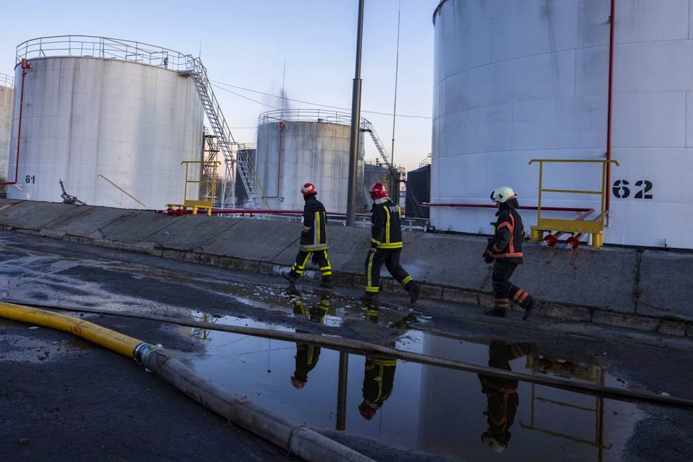 Firefighters work at the site in the aftermath of the first strike that involved Russian rockets that hit an oil facility in an industrial area in the northeastern outskirts of Lviv, Ukraine, Sunday, March 27, 2022. (AP Photo/Nariman El-Mofty)